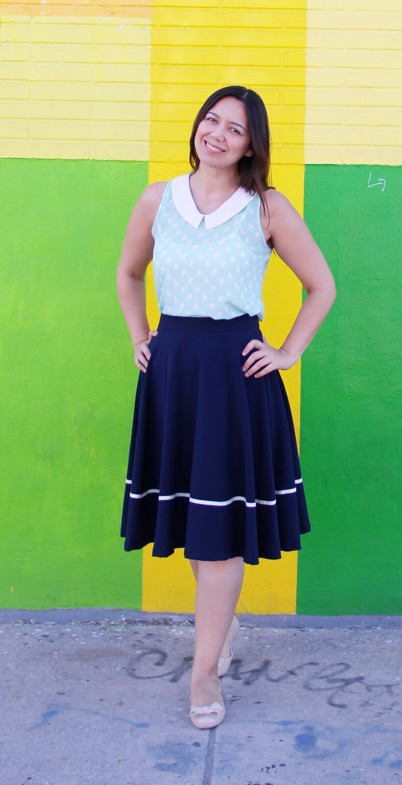 Cat patterned peter pan collar top with navy midi skirt and nude ballet flats.