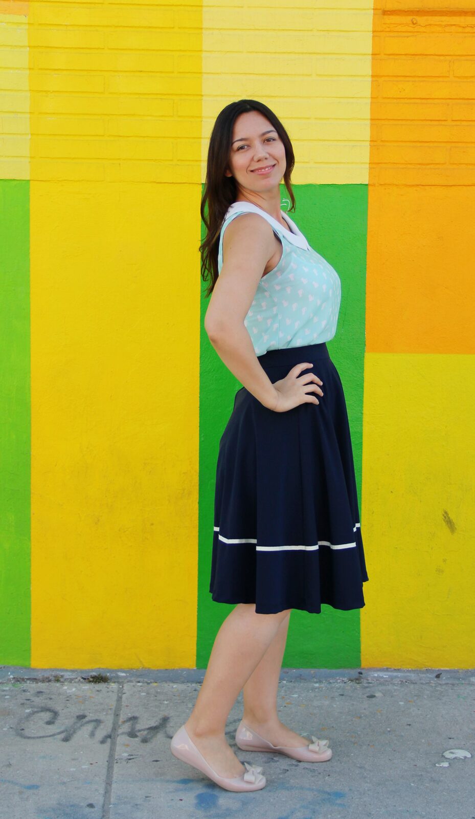Cat patterned peter pan collar top with navy midi skirt and nude ballet flats.