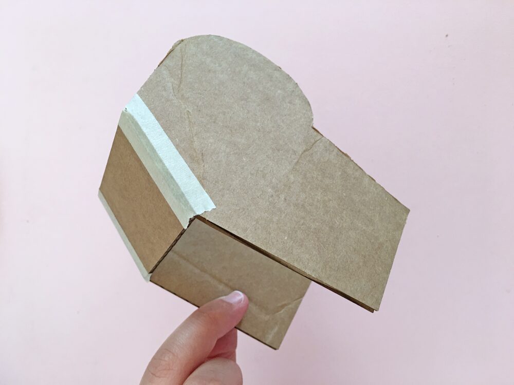 How To Make a Felt Dinosaur Bag Tutorial: Tape the back of head piece to the side head pieces