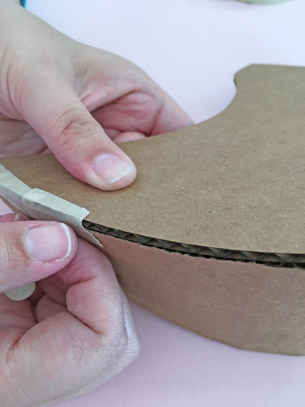 How To Make a Felt Dinosaur Bag Tutorial: Tape the belly piece to the side piece. Make sure to math the two pointy tail sides.